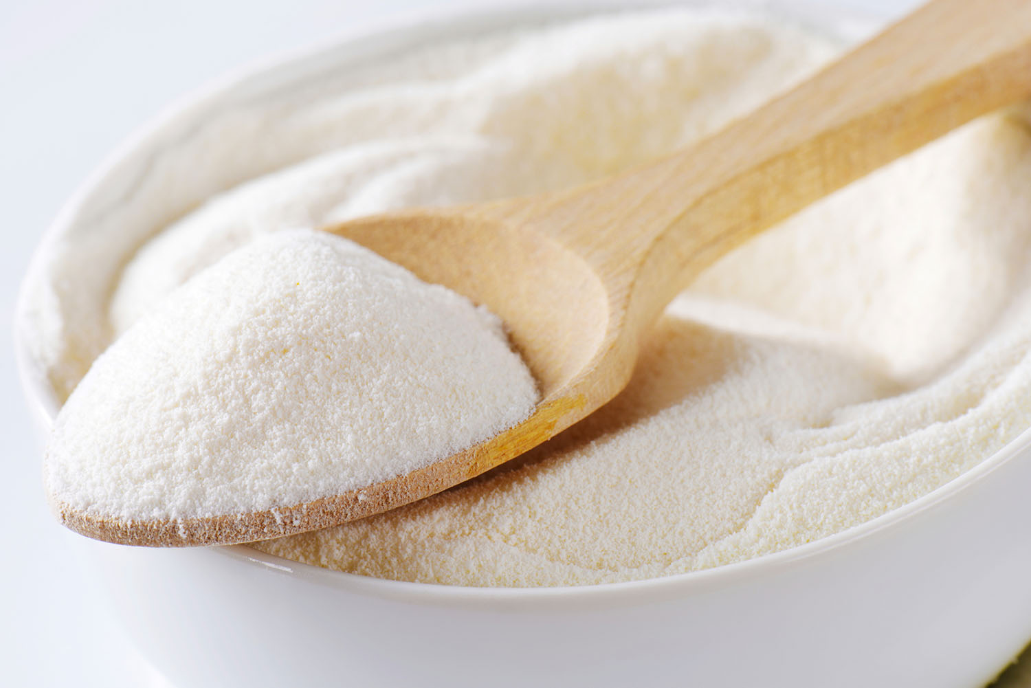 Bowl and spoon full of milk powder